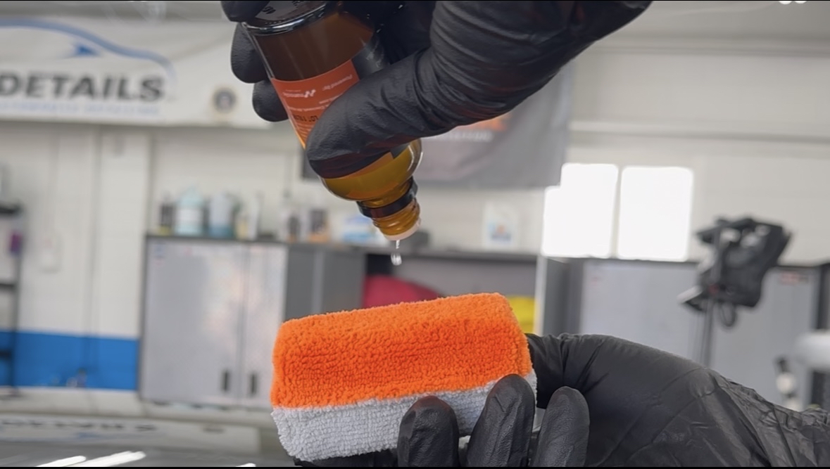 A ceramic coating applicator pad being primed with DuraSlic ceramic coating